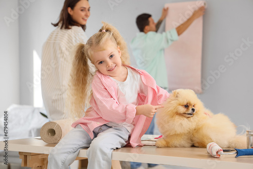 Little girl with cute dog d...