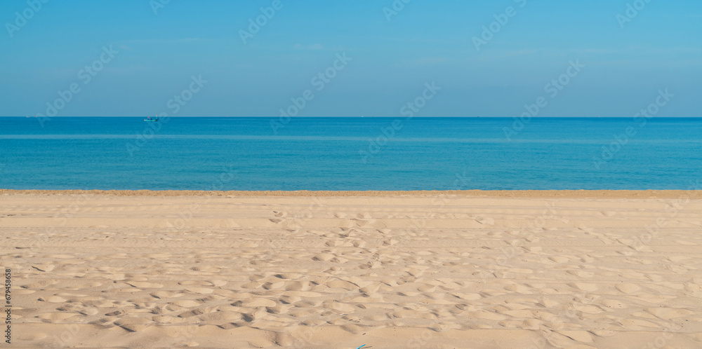 Tropical sea beach with sand, ocean and blue sky