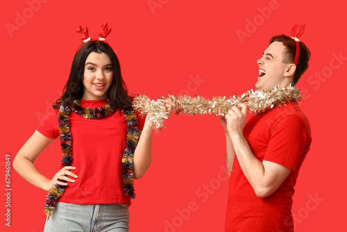 Joyful young couple in rein...