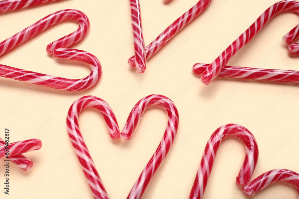 Hearts made of Christmas candy canes on yellow background Hearts made of Christmas candy canes on yellow background