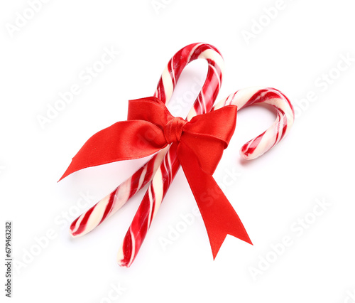 Christmas candy canes with bow on white background