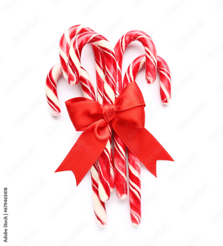 Many Christmas candy canes with bow on white background Many Christmas candy canes with bow on white background