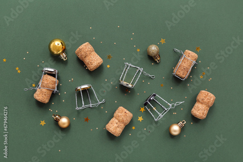 Champagne corks with Christmas decor on green background photo