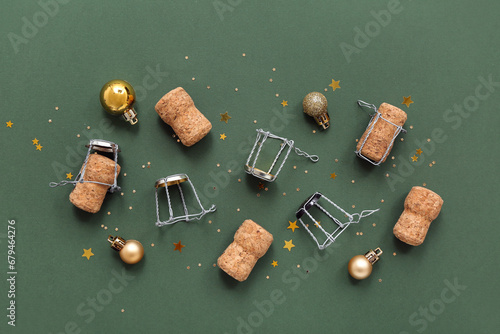 Champagne corks with Christmas decor on green background