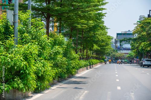 Hanoi street with green tree lines on Kim Ma street photo