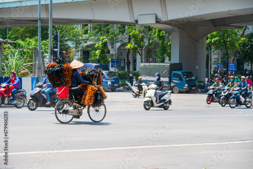 Hanoi street traffic with vendor cycling on Kim Ma street