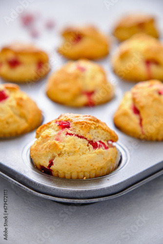 Muffins with red currants in the form for baking