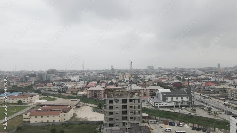 Ascending above a construction site, a drone observes the dynamic activity, gradually revealing the vibrant cityscape of Lekki, Lagos, Nigeria, capturing the synergy of urban development Ascending above a construction site, a drone observes the dynamic activity, gradually revealing the vibrant cityscape of Lekki, Lagos, Nigeria, capturing the synergy of urban development