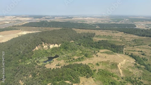 Airplane Landing. Beautiful aerial view of landscape from window of landing aircraft. Viewing airport from the passenger cabin window. Airplane Window Seat 