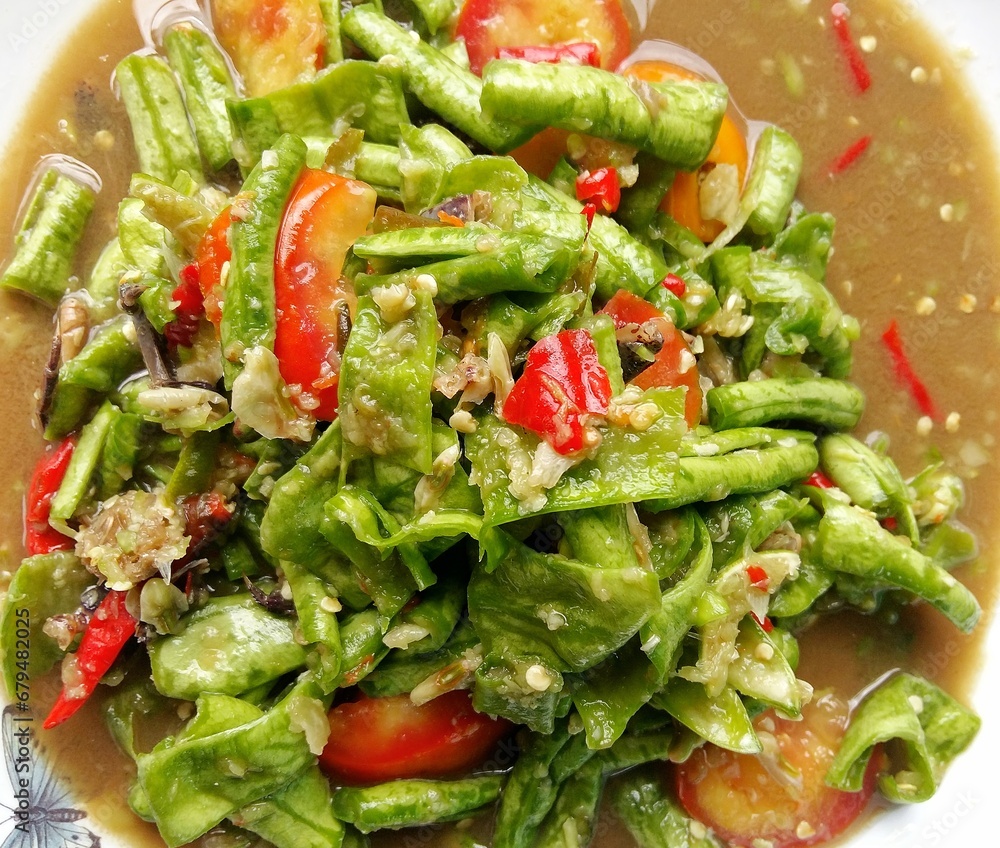 Fresh green salad with vegetables and peppers on a white plat Fresh green salad with vegetables and peppers on a white plat