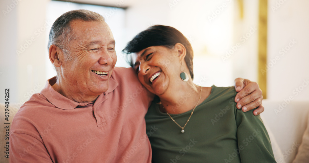 © Azeemud/peopleimages.com - Happy couple, together and embrace on sofa in living room with laugh for funny joke, conversation or talk. Senior man, woman and hug for love, care or support with marriage, bond and communication