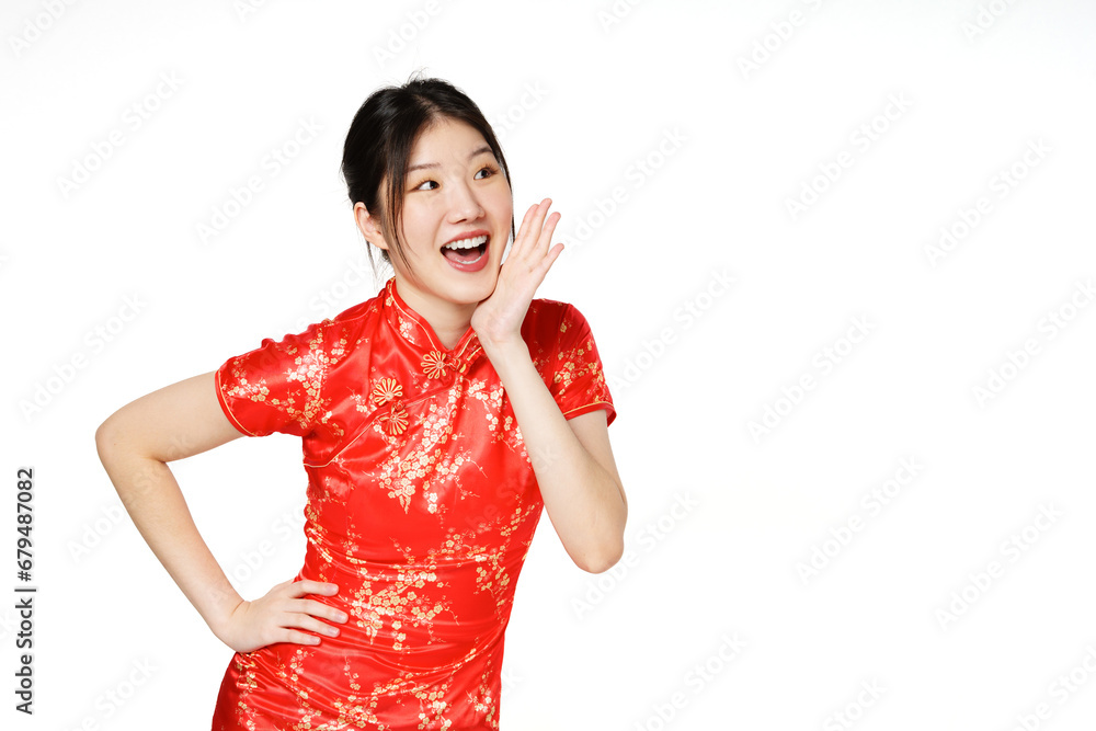 Asian woman wearing traditional cheongsam qipao dress with gesture shouting and holding palm near opened mouth isolated on white background. Happy Chinese new year. Asian woman wearing traditional cheongsam qipao dress with gesture shouting and holding palm near opened mouth isolated on white background. Happy Chinese new year.