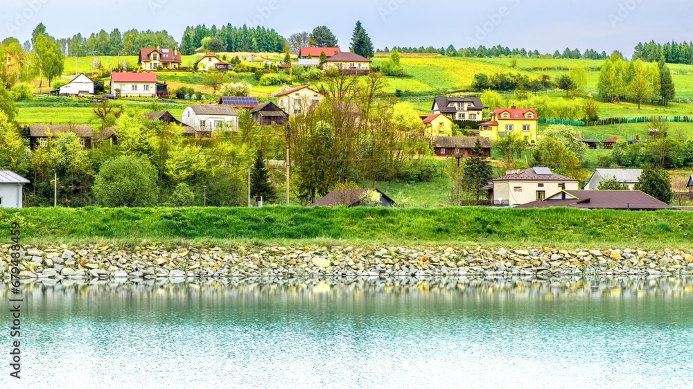 A village on the bank of a small river. Spring landscape. Poland.