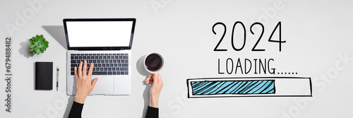 Loading new year 2024 with person using a laptop computer