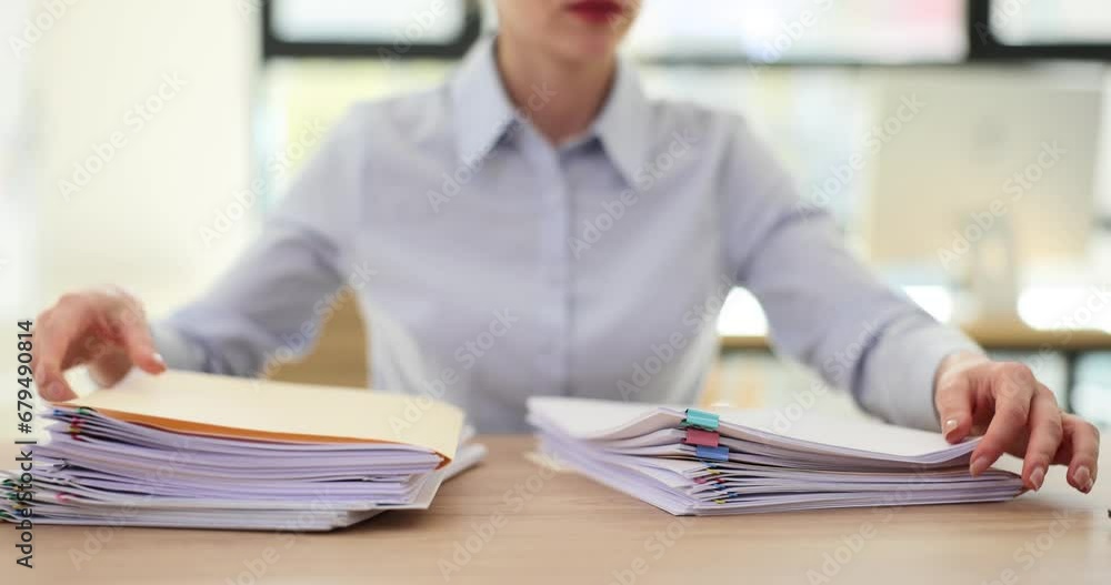 Business woman puts financial documents on table Business woman puts financial documents on table