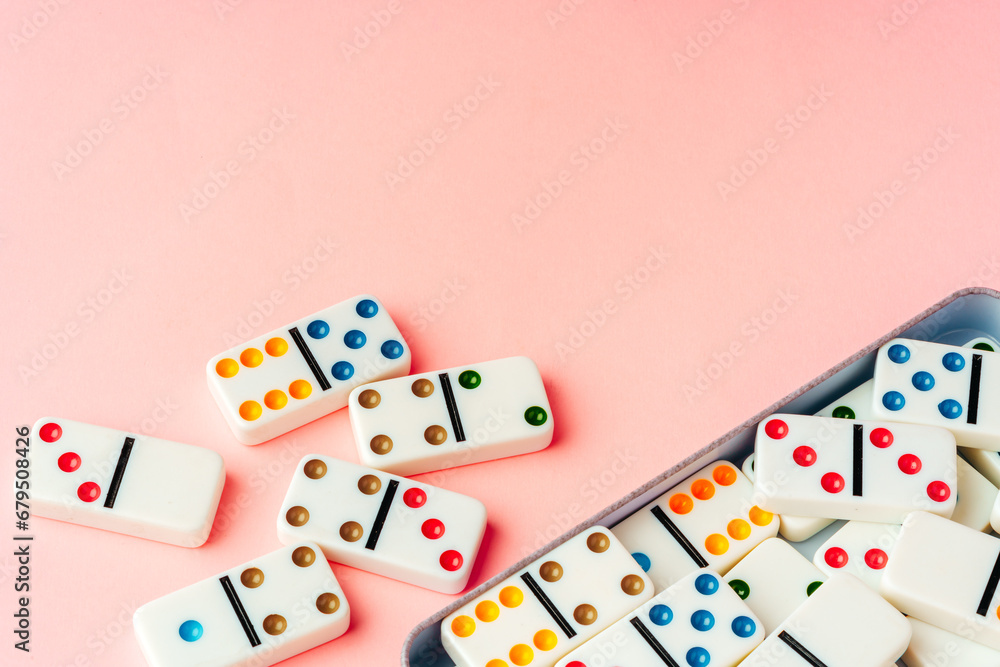 Domino tiles on pink background studio shot Domino tiles on pink background studio shot