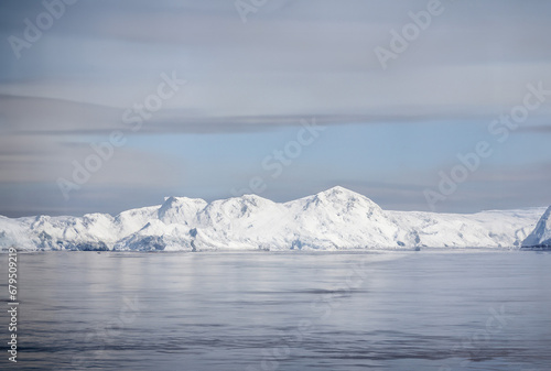 icecaps in the Antarctica with iceberg in the ocean swimming around and melting in the sea © Robert Kiyosaki