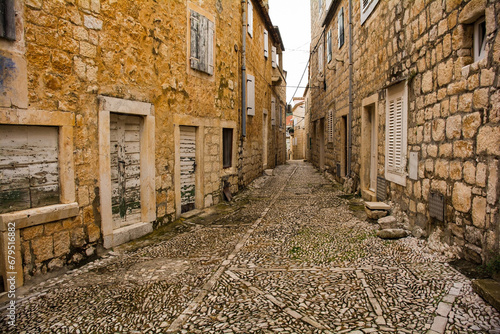 A street in Sutivan, Brac Island, Croatia, with traditional kogule or kogulavanje paving. Common in coastal villages in Dalmatia, it uses beach pebbles
