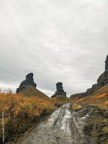 Two brothers rocks near Cape Zemlyanoi on the Kola Peninsula. Natural weathering pillars. The rocky coast of the Barents Sea. The ancient sanctuary of the Sami. Arctic Russia.