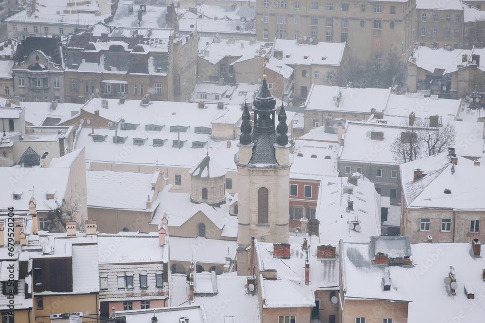 Winter snowy city, top view. Bell tower of the Armenian Church in Lviv, Ukraine.