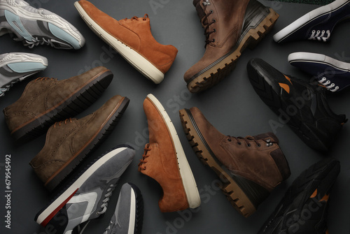 Vászonkép Different pairs of men's shoes, sports and classic on a gray background