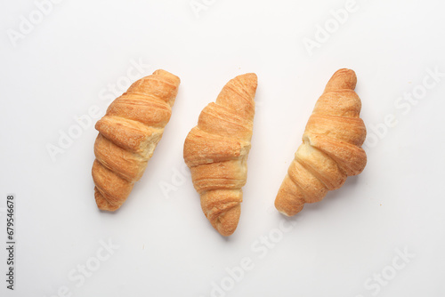 Three appetizing croissants on a white background