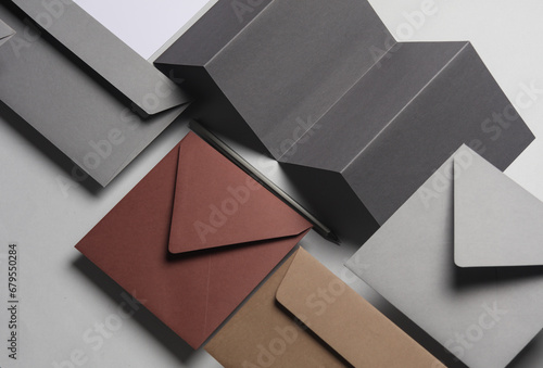 Floating envelopes and brochure, cards on gray background with shadow. Minimalism, modern business still life, creative layout