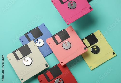 Floating colored retro 80s floppy disks on a blue background. Conceptual pop, creative layout photo