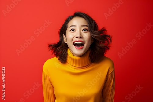 Wallpaper Mural Surprised happy asian woman in sweater coat and looking at the camera yellow red colorful background concept Torontodigital.ca