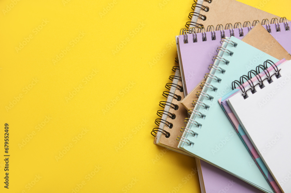 Stack of notepads on yellow background Stack of notepads on yellow background