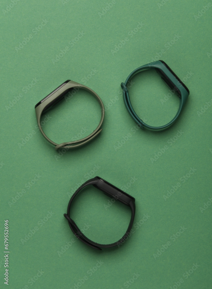 Three smart bracelets on a green background Three smart bracelets on a green background