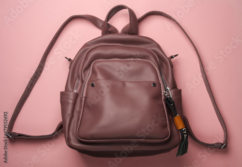 Leather backpack on pink background