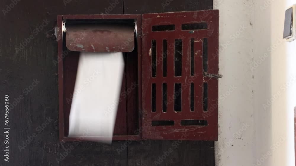 Letters are thrown into the old mailbox on the door Letters are thrown into the old mailbox on the door