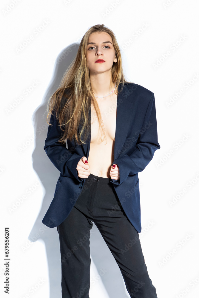 Calm Caucasian Blond Girl Posing in Blue Jacket Against Pure White Background