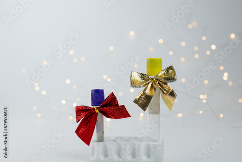 Christmas in laboratory. Medical test tubes with christmas bows and christmas lights on background