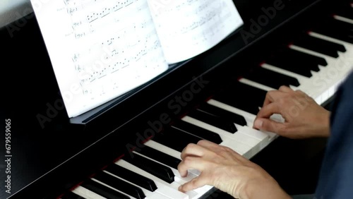 Close up movie camera in slow motion Male pianist plays fast music on piano photo