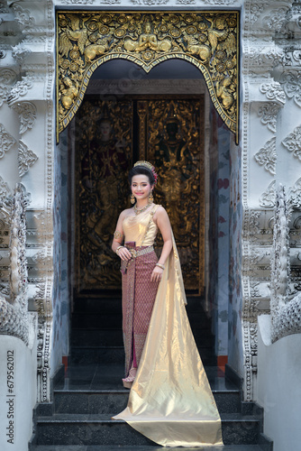 Beautiful portrait fashion of an Asian woman wearing an Elegant Thai dress wedding costume which is popular according to Thai culture at Wat Pa Dara Phirom Temple in Chiang Mai, Thailand. © pomphotothailand