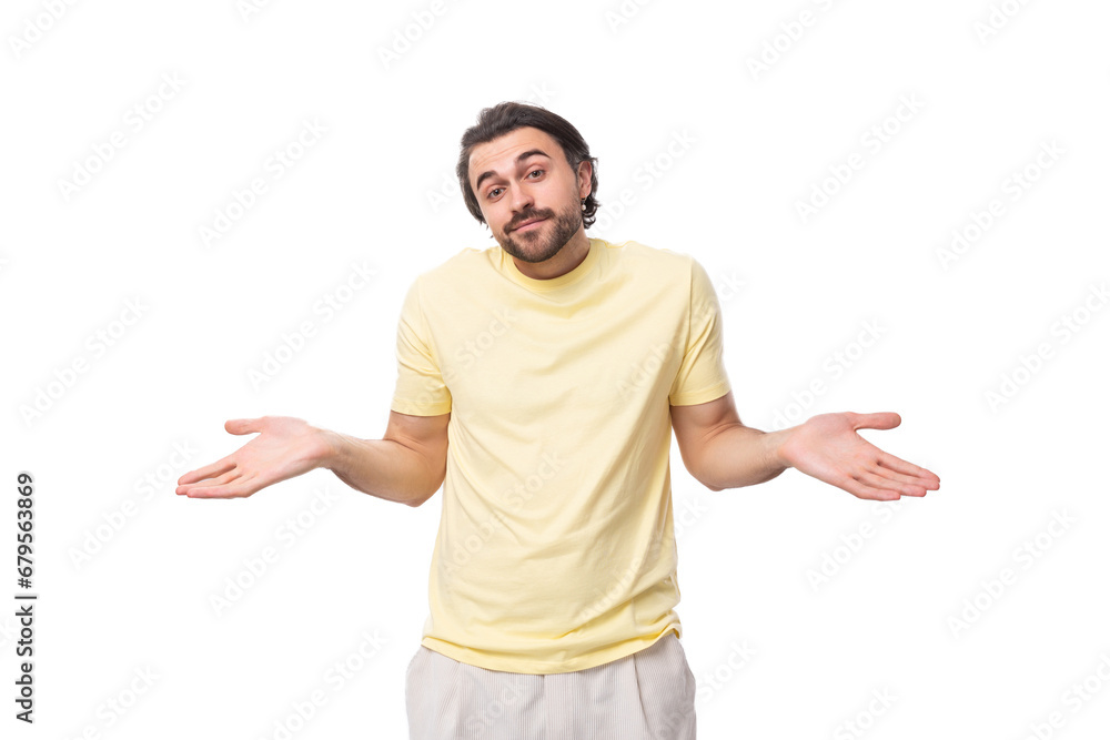 caucasian smart brutal charming guy with a beard dressed in a summer t-shirt shrugs his shoulders caucasian smart brutal charming guy with a beard dressed in a summer t-shirt shrugs his shoulders