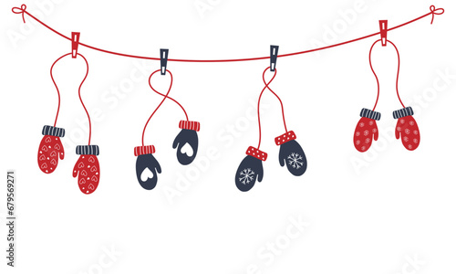 Red and blue mittens are hung on clothespins with a winter ornament. Garland of mittens. Cozy winter clothes