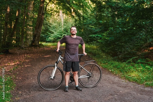 Man rides a bicycle. Exploring nature. Into the Wilderness. Cycling Adventure in the Forest