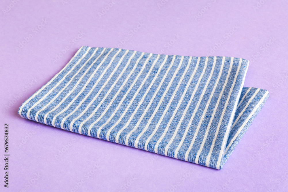 top view with blue kitchen napkin isolated on table background. Folded cloth for mockup with copy space, Flat lay. Minimal style top view with blue kitchen napkin isolated on table background. Folded cloth for mockup with copy space, Flat lay. Minimal style