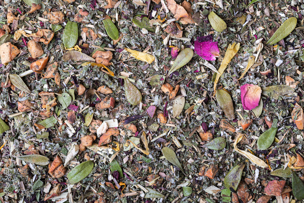 Dried natural large tea leaves close up. Crushed Sudanese rose flowers, chopped mint and raspberry leaves, currant and lingonberry leaves, tea rose petals, apple pieces. Dried natural large tea leaves close up. Crushed Sudanese rose flowers, chopped mint and raspberry leaves, currant and lingonberry leaves, tea rose petals, apple pieces.
