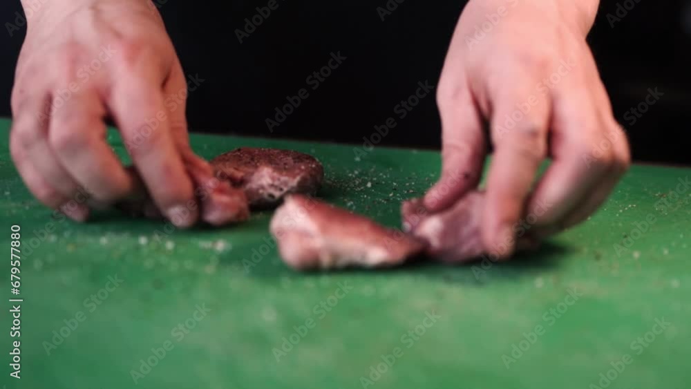Man chopping and seasoning pork meat Man chopping and seasoning pork meat