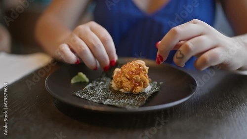 Gorgeous hispanic woman savoring exquisite uni sushi, a culinary feast of japanese seafood delicacy in chic restaurant photo