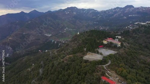 An aerial shot of Queen of the Hills which is Mussorrie  being surrounded by Greenery and Blue Sky 
 photo