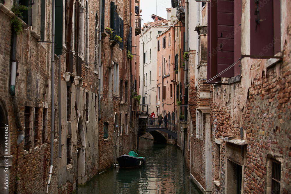 Ancient residential houses built on the canal. Old Venetian buildings in historic district. Venice - 5 May, 2019