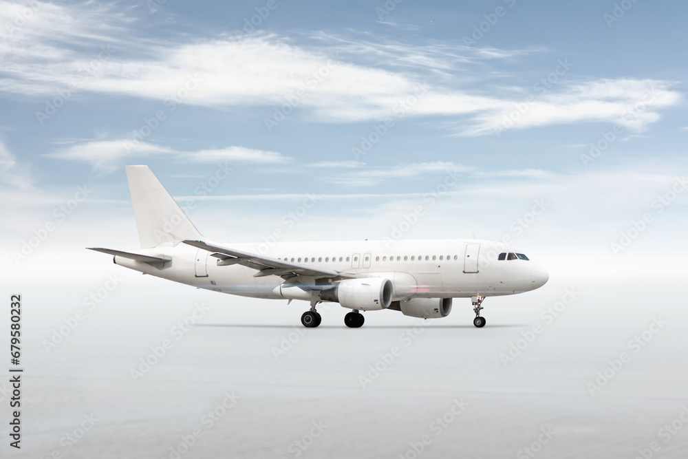 White passenger airliner isolated on bright background with sky