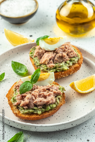 sandwiches with canned tuna, boiled egg and avocado. vertical image. top view. copy space for text