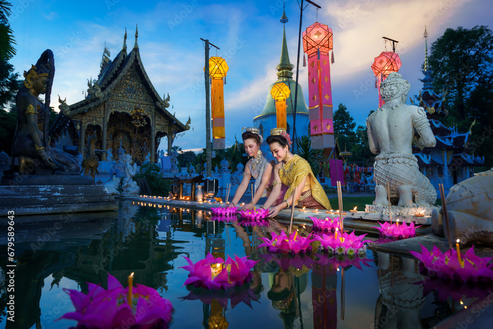 Pretty Asian Thai women holding a Krathong floating on water, Asian women in traditional Thai dress bring Krathong to float on Loy Krathong Festival Day, Popular traditions culture of Thailand. - obrazy, fototapety, plakaty 