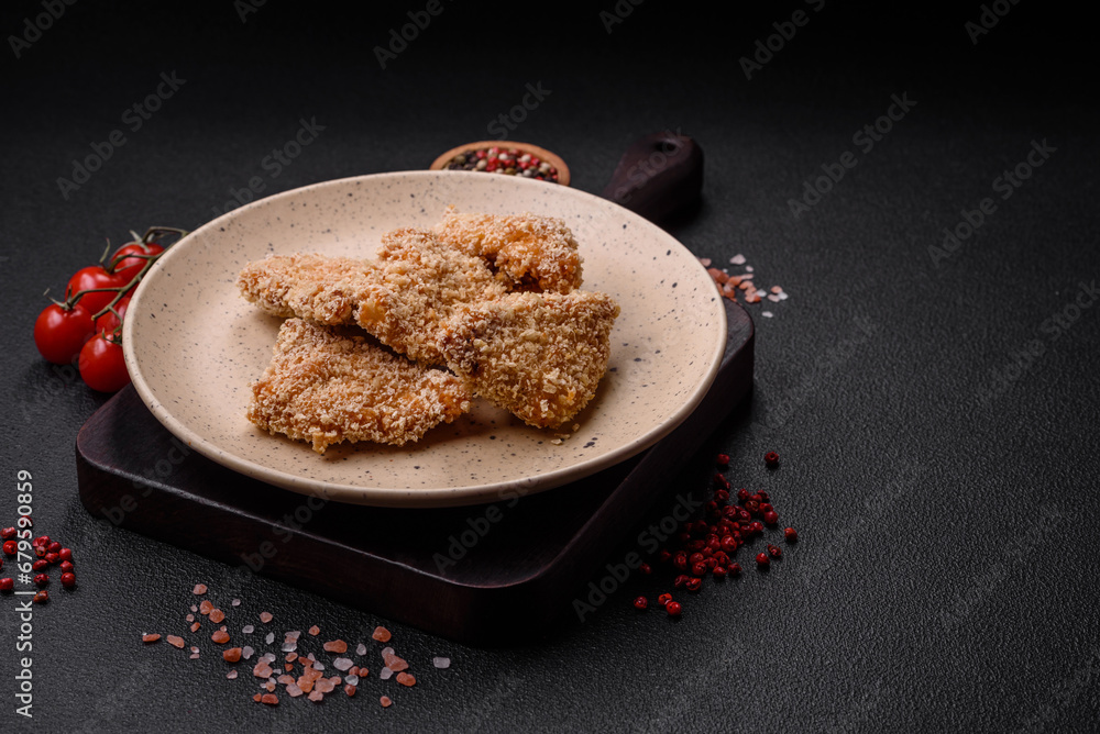 Delicious fresh crispy chicken nuggets on a dark concrete background Delicious fresh crispy chicken nuggets on a dark concrete background